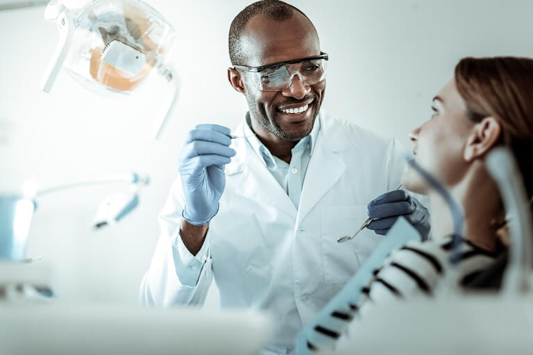 Dentista realizando procedimento em paciente.